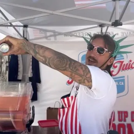 Pouring Freedom Juice at the festival booth