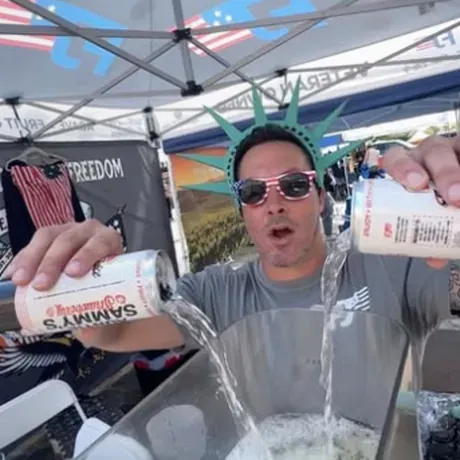 Pouring Liberty Lime and Auntie Sammy's under the Freedom Juice canopy