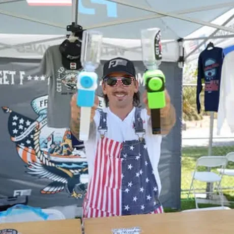 The Freedom Juice booth, loaded squirt rigs and the merch wall behind it